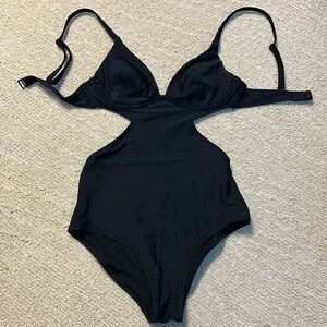 One piece swim suit with cut out detail, adjustable straps. Never worn.